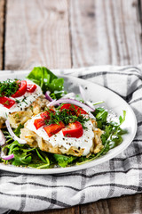 Potato cakes with sour cream and vegetables