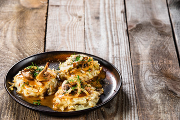 Potato cakes with gravy sauce and champignon