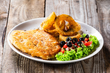 Fried pork chop, onion rings and vegetables