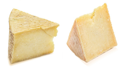 Cured sheep cheese (manchego type). Two wedges and portions. Isolated on white background.