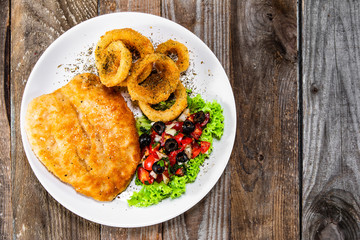 Fried pork chop, onion rings and vegetables
