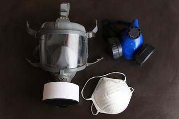 Different selection of respirators or face masks.The masks are designed to protect your lungs from different levels of hazardous materials that could damage the lungs. - obrazy, fototapety, plakaty