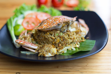 Fried rice with crab on dish with spoon/Crab fried rice with curry powder,onion/Kao pad poo/