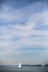A lone sail boat on the river Deben sailing on a clear summers day. Photo contains plenty of copy space