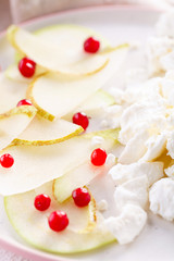 cottage cheese with slices of pear, Apple and cranberries