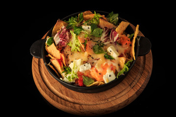 modern decorated cheese and greens salad over black background