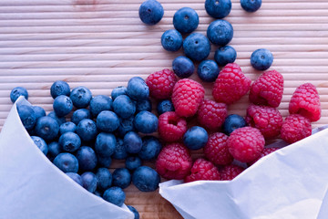Berries frame on a wooden background, blueberry, raspberries