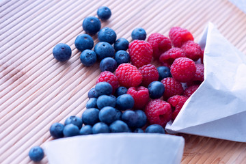 Berries frame on a wooden background, blueberry, raspberries