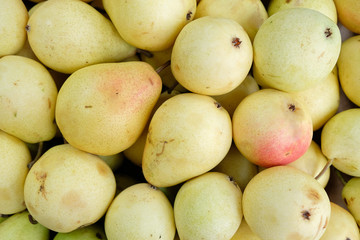 pile of fresh pears in the market closeup