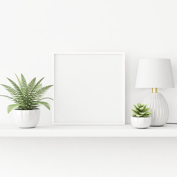 Interior poster mockup with square white frame standing on the table with plants in pots and lamp on empty wall background. 3D rendering, illustration.