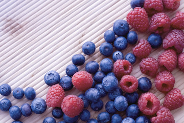 Berries frame on a wooden background, blueberry, raspberries