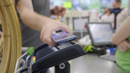 The buyer in the store pays for the goods by phone, contactless payment.
