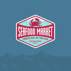 Seafood market or restaurant logo. Red Crab silhouette and blue sea wave. Fresh sea products.