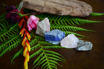 Rough crystals in woman's hand with natural lighting. Raw Rose Quartz, Raw Lapis Lazuli, Raw...