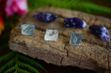 Tumbled Amethyst & Mini Fluorite Octahedron - Miniature Healing Crystal bundle, great witchy gift, magick crystals. Crystals on wood desk, healing stone mock up with copy space and low exposure. 
