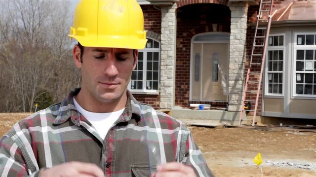 Construction: Home Builder Puts On Safety Glasses And Crosses Arms