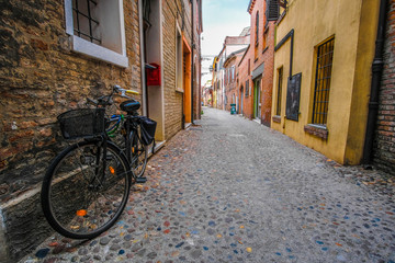 Ferrara, Italy - July,  , 2019: bycicle on a strett of Ferrara , Italy