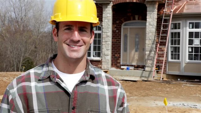 Construction: Builder Puts On Hard Hat For Safety