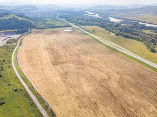 Aerial view not a landscape in fields with agricultural plants for growing cereals and hay. Farming and industry.