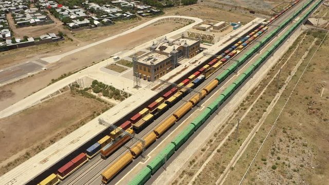 China Africa relations and infrastructure development - Tilting drone shot flying over cargo trains parked at Adama station in Ethiopia, railway line built and partly financed by Chinese government