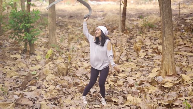 Slow motion of happy young woman enjoying holiday while dancing at the autumn park. Shot outdoors
