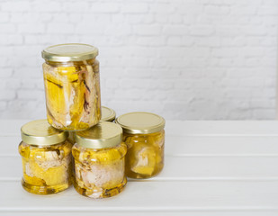 Glass jars of canned tuna on white background. Copy space.
