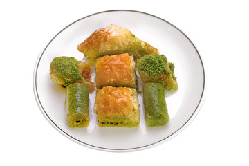 assorted baklava and turkish dessert on plate on white background