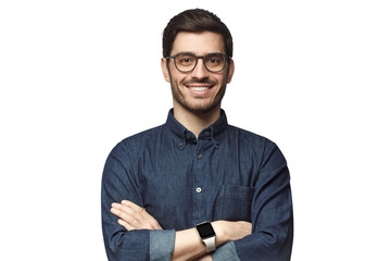 Portrait of young smiling caucasian man with crossed arms, wearing smart watch and casual denim...