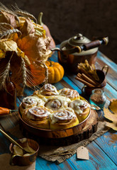 cinnamon rolled pumpkin buns with white sticky glaze on top