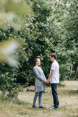summer day in the forest Park. young couple walking in the woods.
