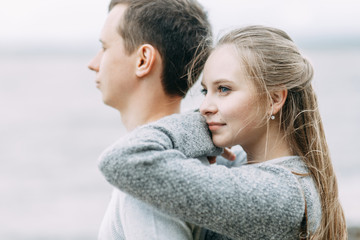 Fototapeta premium a walk in the woods by the pier. young couple walking on the lake.