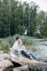 Fototapeta premium a walk in the woods by the pier. young couple walking on the lake.