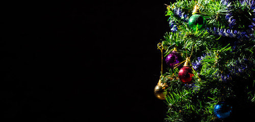 christmas tree decoration on a dark black background with copy space.