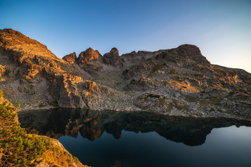 Fototapeta na wymiar Amazing landscape of The Scary lake during warm summer sunset, Rila mountain national park, Bulgaria
