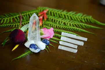 Variety of Healing Crystals on wood table. Witchy crystal set up, alter of crystals Bohemian decorations, rainbow crystals. Quartz tower, Selenite, sodalite, Clear Quartz. Meditation Grid Kit