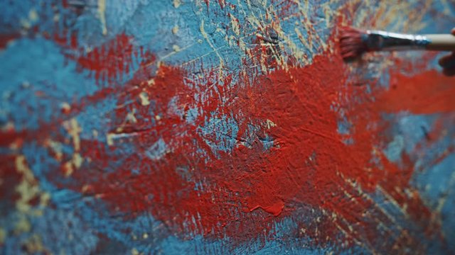 Close-up Shot of Female Artist Hand, Holding Paint Brush and Drawing Painting with Red Paint. Colorful, Emotional Oil Painting. Contemporary Painter Creating Modern Abstract Piece of Fine Art
