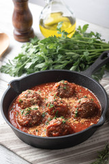 meatballs with tomato sauce in cast iron skillet