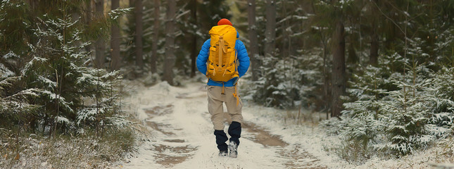 winter landscape man with a backpack / nature landscape a man on a hike with equipment in snowy...