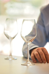 Photo of wineglass on table against customer at restaurant