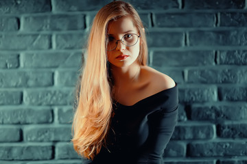 Fototapeta premium serious young woman with glasses / businesswoman serious look in glasses. concept vision business, youth