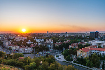Fototapeta na wymiar Warm summer sunset from Nebet tepe Hill in Plovdiv city, Bulgaria. Panoramic view from the oldest european city. Ancient city is UNESCO's World Heritage.