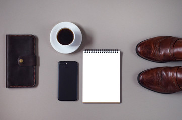 Men's flat lay with a lot of accessories and a notebook.