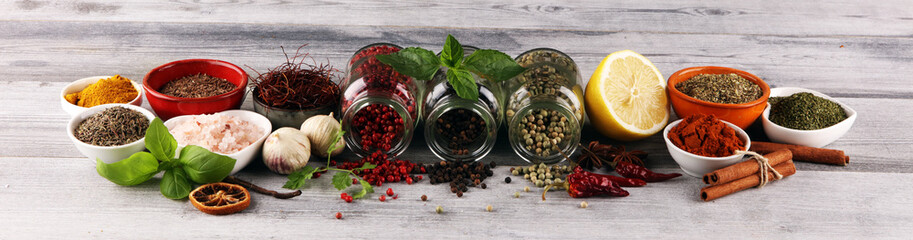 Spices and herbs on table. Food and cuisine ingredients with basil - obrazy, fototapety, plakaty