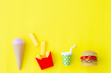 Toy fastfood food and drink on an yellow background.