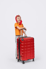 Excited little traveler with luggage