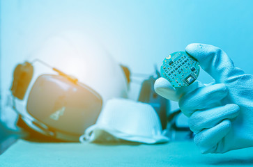Hand holding tiny electronic circuit board inserting to the socket, abstract technology background,...