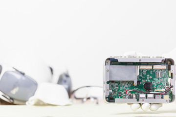 Hand holding tiny electronic circuit board inserting to the socket, abstract technology background,...