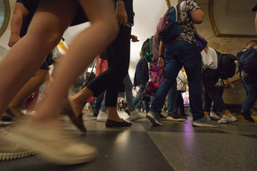 Defocused photography of people legs going in the subway. Concepts of metro congestion at rush...