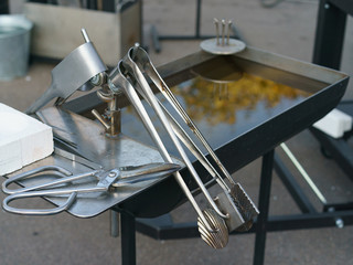 Photography of the process of making beads in the workshop. Man glassblower make handmade products...