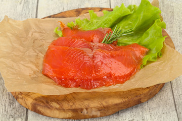 Sliced salmon fillet served rosemary